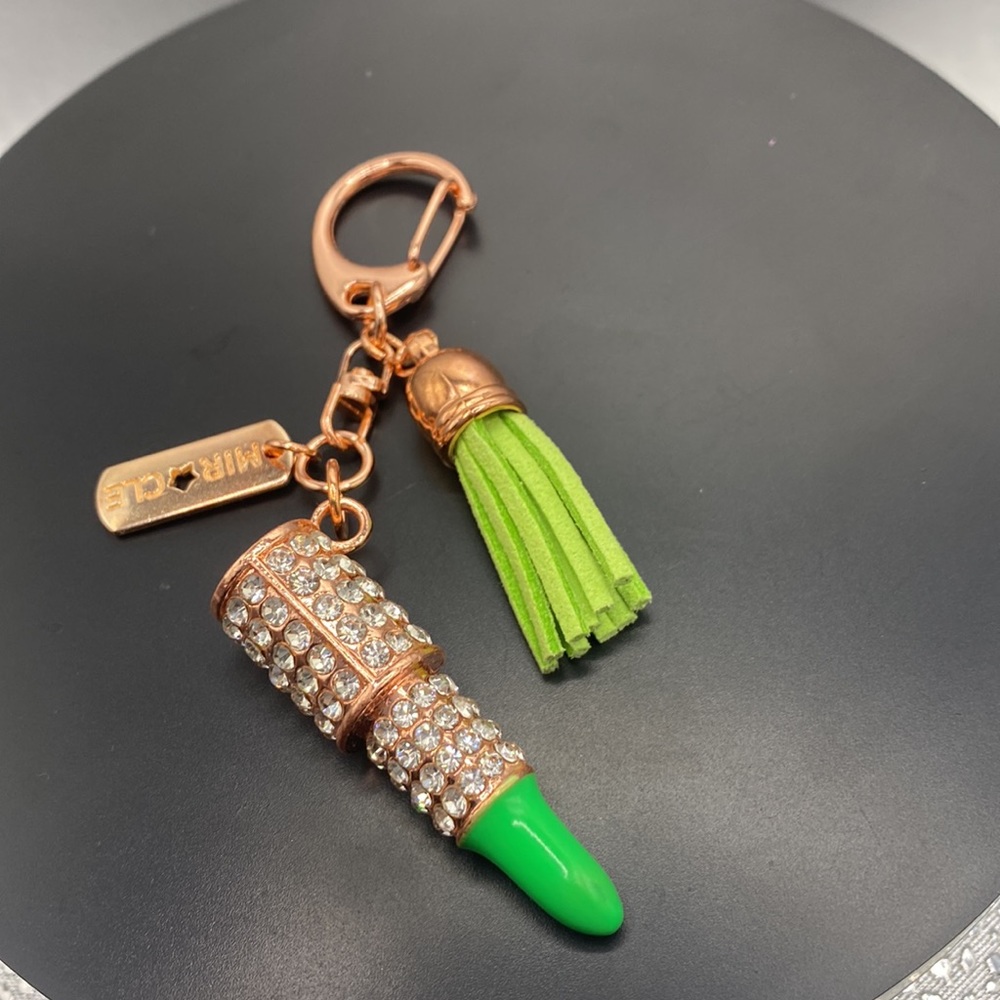 Rose gold tone green lipstick crystal key chain with miracle on rose gold tag